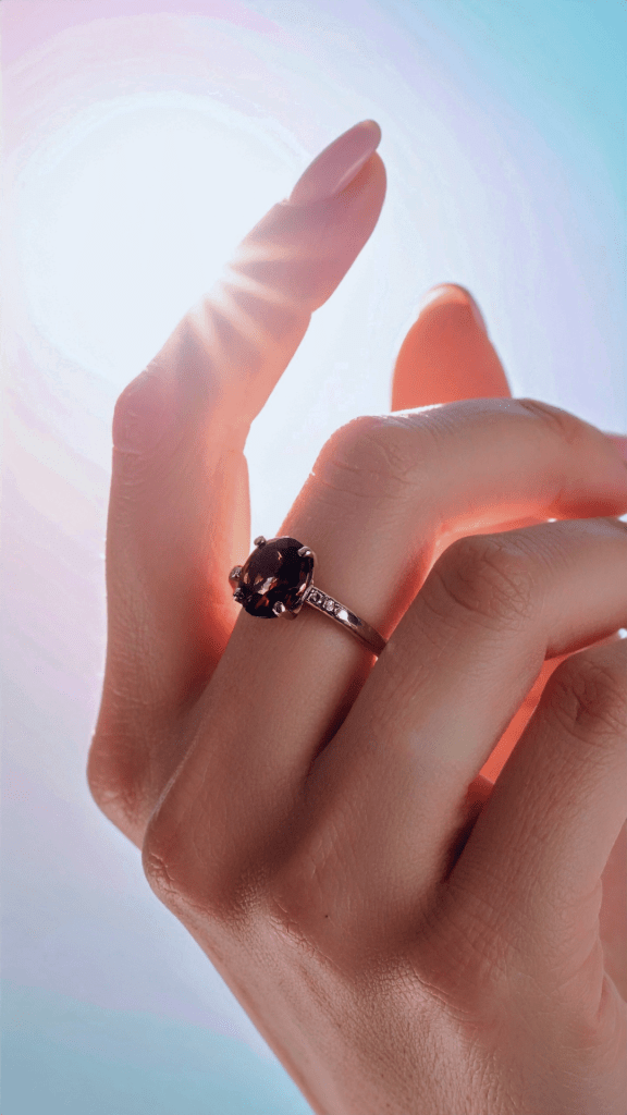 A closup on a hand on a sunny sky background with a beautiful Jyotish birth chart astrological gem remedy on it.