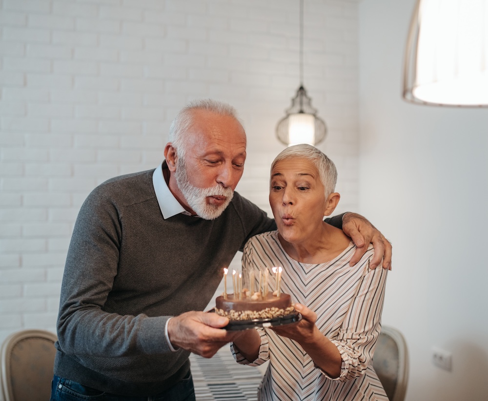 A happy senior couple relaxing together and celebrating a birthday. A concept of Jyotish view on birthday and any action to be done at the right time as per vedic sciences